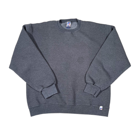 Folded gray sweatshirt with brand logo on a white background