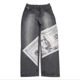 Gray jeans with a printed design of a dollar bill on a white background