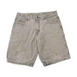 Pair of worn denim shorts on a white background