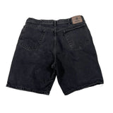 Black denim shorts on a white background