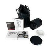 Vivitar 500mm mirror lens kit with a black lens, black leather drawstring bag, filter accessories, lens cap, and instruction booklet on a light gray background.